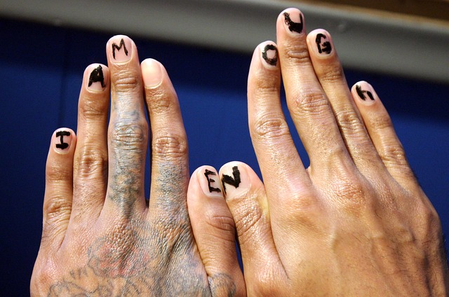 hands with I am enought painted on the nails